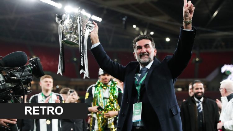 Newcastle United chairman Yasir Al-Rumayyan holds the Carabao Cup in the air.