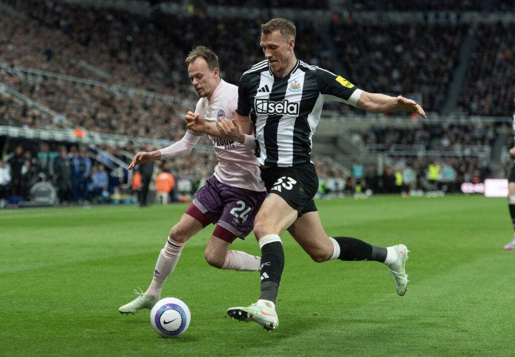 Dan Burn and Mikkel Damsgaard challenge each other for the ball.