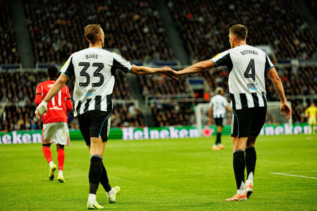 Dan Burn and Sven Botman in action for Newcastle United