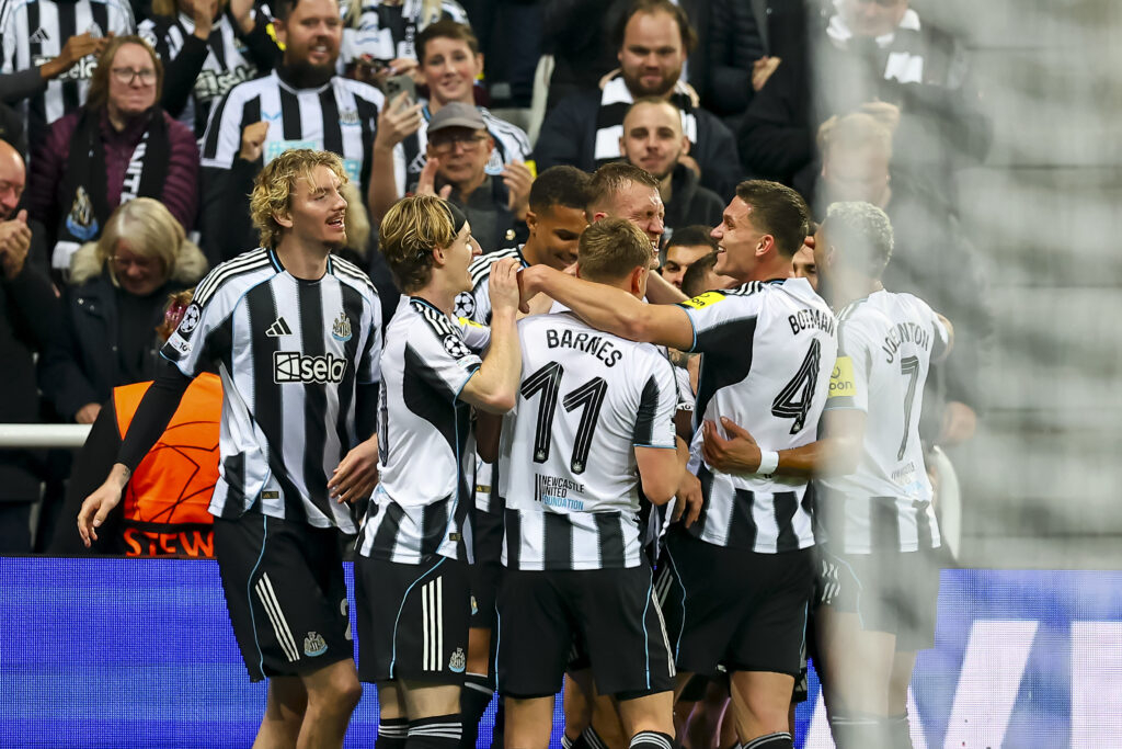 Newcastle United players celebrate scoring vs Club Athletic.