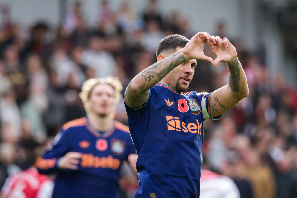 Bruno Guimaraes does a heart gesture during Newcastle United's game against Brentford.