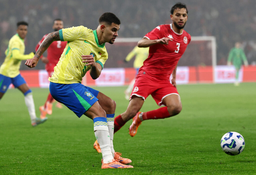 Bruno Guimaraes kicks the ball for Brazil against Tunisia.