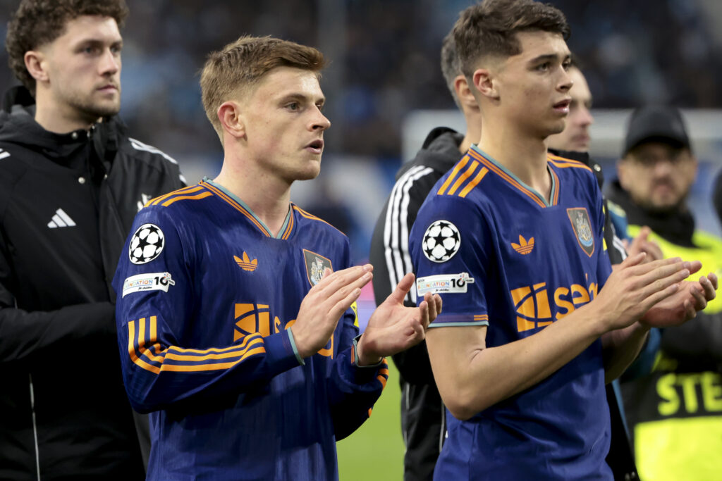 Harvey Barnes and Lewis Miley salute the Newcastle United fans after their Champions League defeat against Marseille.