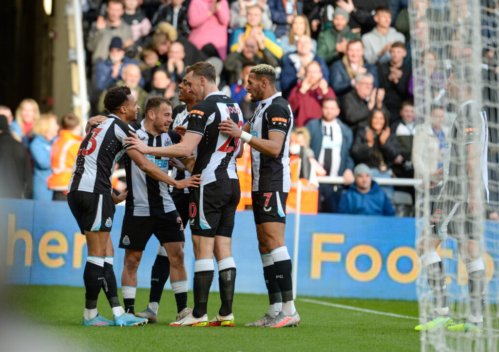 Newcastle United players celebrate scoring against Brighton.
