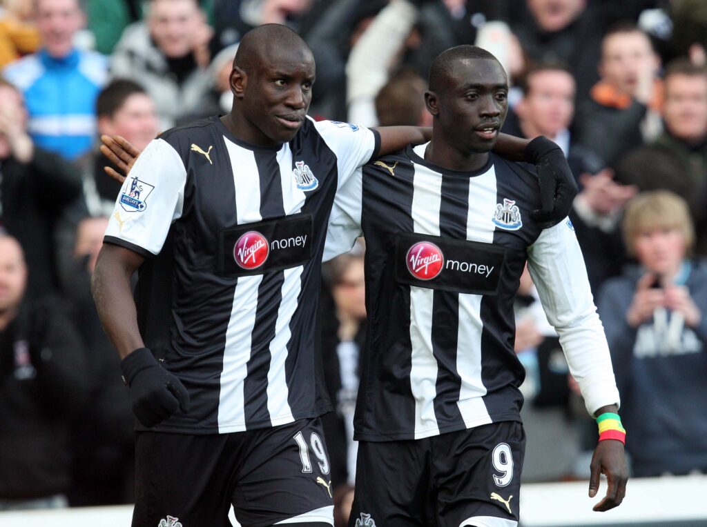 Demba Ba and Papiss Cisse celebrate Newcastle United's goal against Aston Villa in the Premier League.