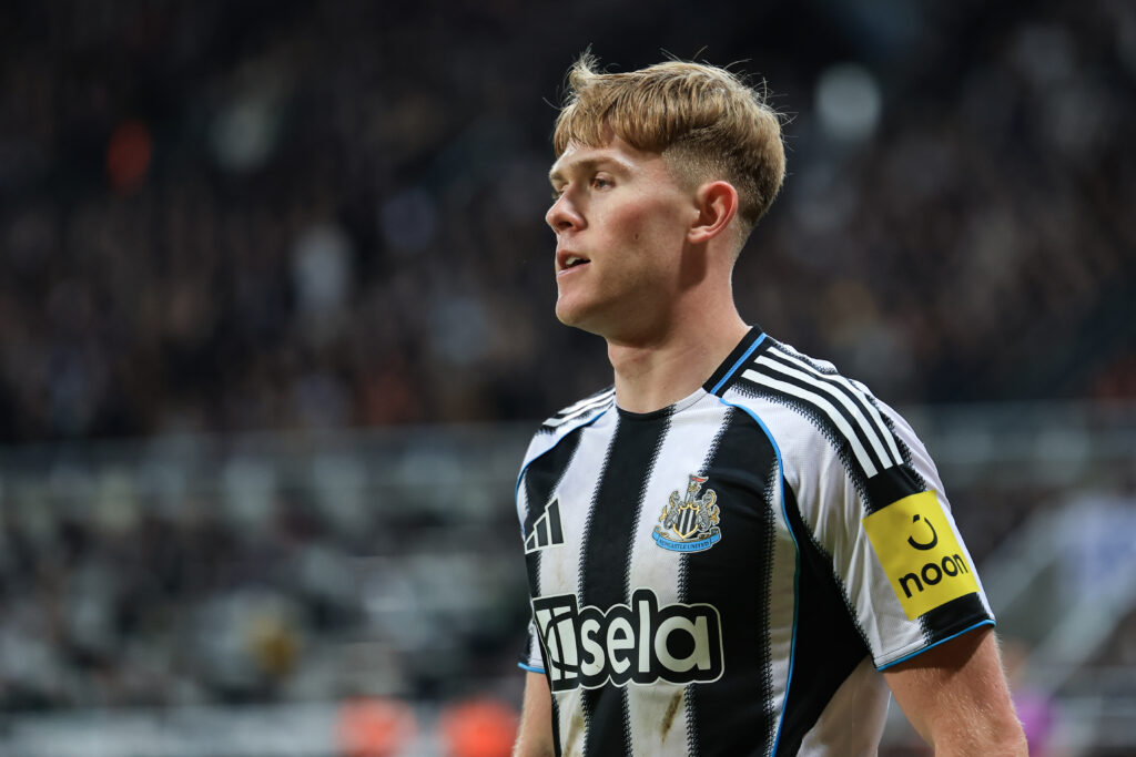 Lewis Hall in action for Newcastle United against Tottenham Hotspur.