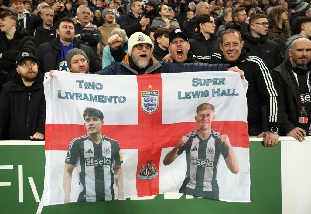 Newcastle United fans pictured with a flag in support of players Tino Livramento and Lewis Hall.