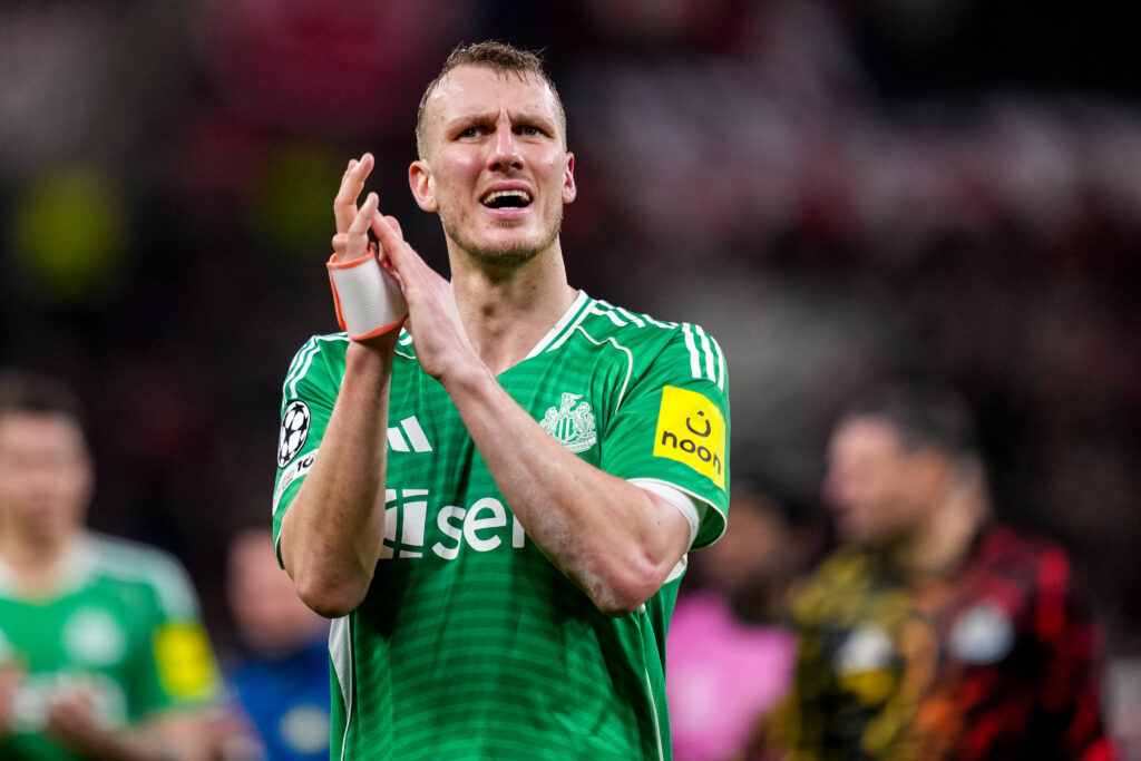 Dan Burn applauds the Newcastle United fans after drawing with Bayer Leverkusen.