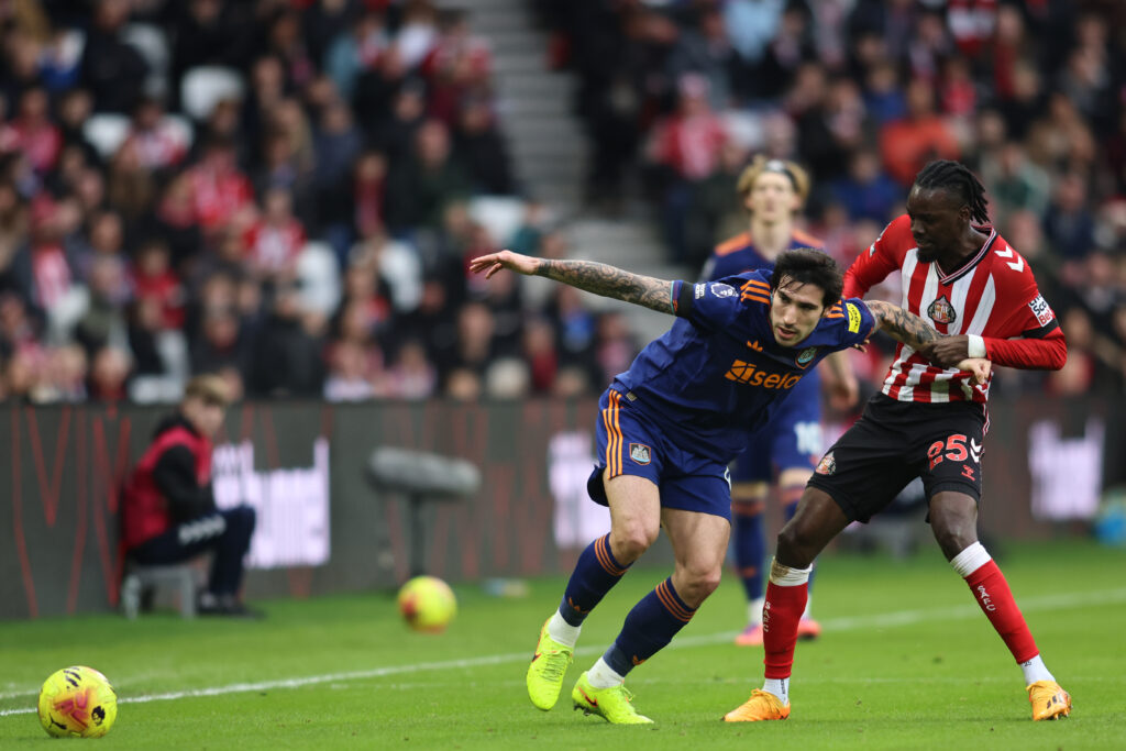 Sandro Tonali is pulled by Bertrand Traore during Sunderland vs Newcastle United.