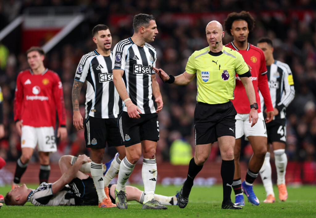 Fabian Schar speaks to referee Anthony Taylor during Manchester United vs Newcastle United.