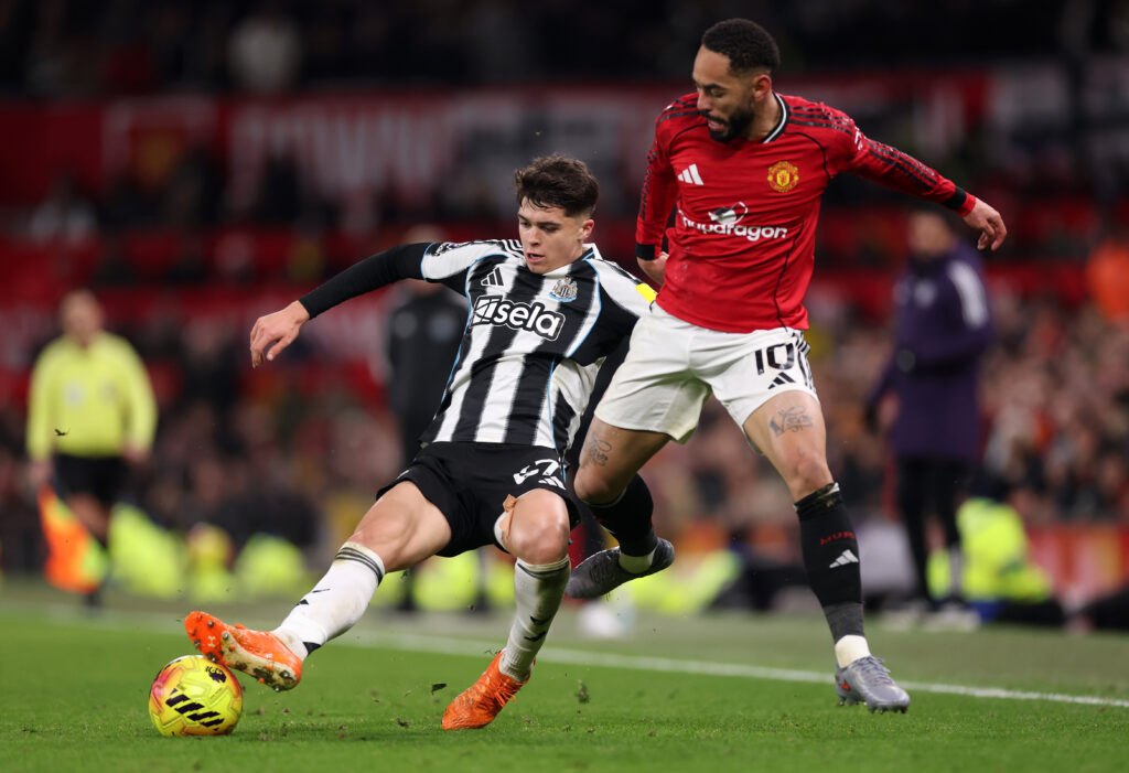 Lewis Miley holds off Matheus Cunha during Manchester United vs Newcastle United.