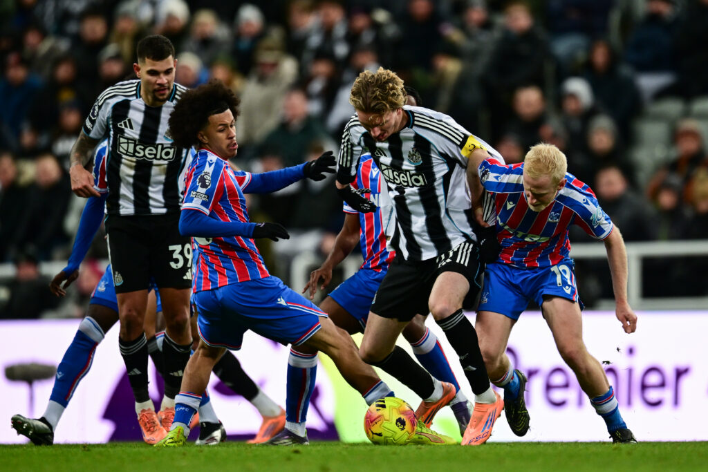 Newcastle United's Nick Woltemade holds off multiple Crystal Palace players.