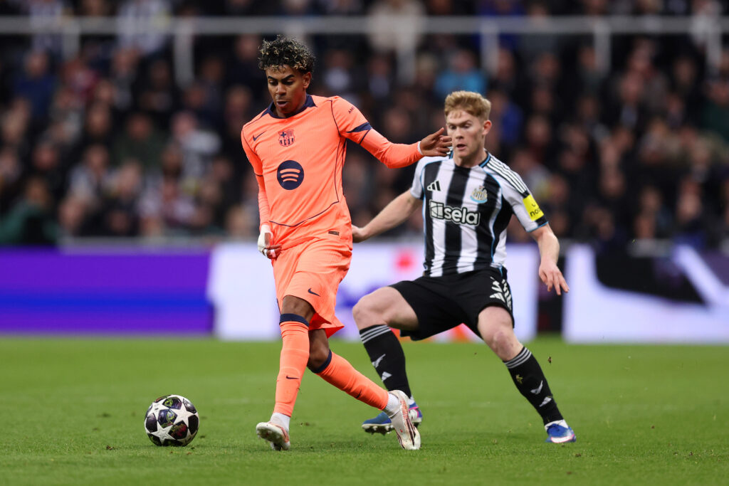 FC Barcelona forward Lamine Yamal is put under pressure by Newcastle United defender Lewis Hall.