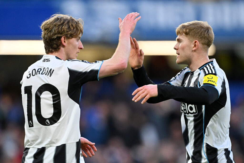 Anthony Gordon celebrates with Lewis Hall after scoring for Newcastle United against Chelsea.