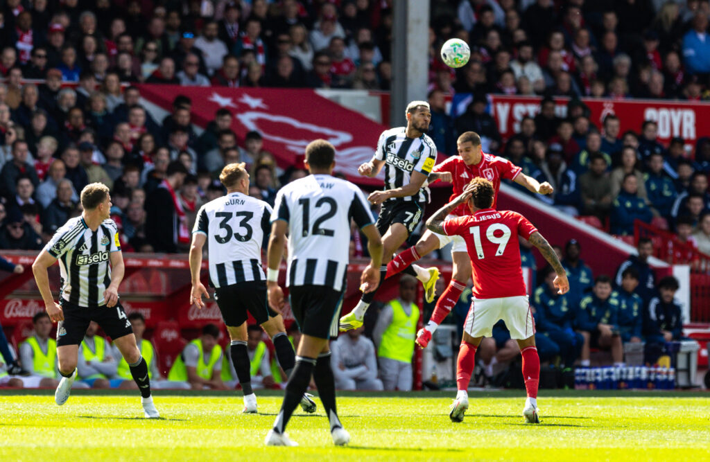 Joelinton wins a header during Newcastle United vs Nottingham Forest.